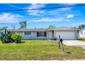 Inviting single-story home with a vibrant front yard and ample parking space, showcasing curb appeal at 5524 25Th W St, Bradenton, FL 34207