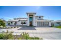 Contemporary home with a striking facade, tall entryway, and modern garage door at 560 Schooner Ln, Longboat Key, FL 34228