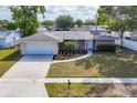 Charming brick home featuring a well-manicured lawn, attached garage, and inviting curb appeal at 6637 Bowline Dr, Sarasota, FL 34231