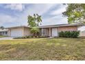 Charming brick home featuring a well-manicured lawn, attached garage, and inviting front door at 6637 Bowline Dr, Sarasota, FL 34231