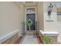 Welcoming entrance featuring a decorative wreath and a charming black gate at 7137 Orchid Island Pl, Bradenton, FL 34202
