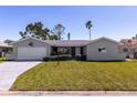 Charming single-story home with a well-manicured lawn and attached one car garage at 7307 14Th W Ave, Bradenton, FL 34209