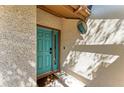 A beautiful turquoise front door with sidelight and textured stucco surround welcomes you home at 7615 4Th W Ave # 7615, Bradenton, FL 34209