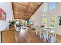 Spacious open concept living room with vaulted wood ceilings and views of the screened-in lanai at 7615 4Th W Ave # 7615, Bradenton, FL 34209
