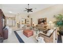 Spacious living room with tile floors, neutral furniture, and a large window at 8024 Via Fiore, Sarasota, FL 34238