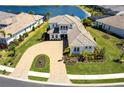 Expansive aerial view of a home with lush landscaping, and paver driveway in a community at 8265 Pavia Way, Bradenton, FL 34202