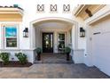 Inviting front porch with double doors, decorative accents, and manicured landscaping at 8265 Pavia Way, Bradenton, FL 34202
