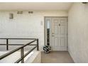Front entrance featuring railing, large door with window, stucco wall, and white flower pot at 8735 Midnight Pass Rd # 301B, Sarasota, FL 34242