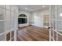 Bright bedroom featuring hardwood floors, built-in shelves and seating, and ample natural light at 875 Siesta Key Cir, Sarasota, FL 34242