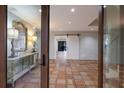 Warm foyer with terra cotta tile and view of a sliding barn door at 875 Siesta Key Cir, Sarasota, FL 34242