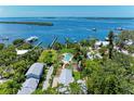 Stunning aerial view of a coastal home with a pool, dock, and picturesque waterfront scenery at 12204 45Th Avenue W Dr, Cortez, FL 34215