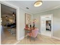 Bright hallway with herringbone floors, a charming desk nook, and open doorways to other rooms at 12204 45Th Avenue W Dr, Cortez, FL 34215