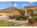 Beautiful house with a tidy landscape, featuring a welcoming entrance framed by lush shrubbery and trees at 12211 Aster Ave, Bradenton, FL 34212