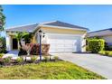 Charming single-story home featuring a well-manicured lawn and a two-car garage and mature landscaping at 12717 Deep Blue Pl, Bradenton, FL 34211