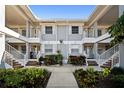 Exterior view of a condo building with lush tropical plants, fresh paint, and charming balconies at 1323 Perico Point Cir # 107, Bradenton, FL 34209