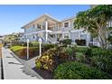 Exterior of a well maintained condominium building with tidy landscaping, lampposts and nicely maintained walkways at 1323 Perico Point Cir # 107, Bradenton, FL 34209
