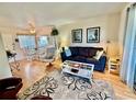 Cozy living room featuring wood floors, neutral walls, and an open dining area at 1633 Leisure Dr # 37, Bradenton, FL 34207