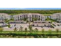 Exterior view of a multi-story residential building with covered parking and manicured landscaping at 17626 Gawthrop Dr # 305, Bradenton, FL 34211