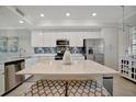 Bright kitchen with stainless steel appliances, quartz countertops, and mosaic tile backsplash at 17626 Gawthrop Dr # 305, Bradenton, FL 34211