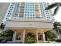 Grand entrance to the building featuring well-maintained landscaping at 1771 Ringling Blvd # 1212, Sarasota, FL 34236