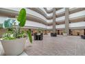 Spacious lobby area with lush greenery and comfortable seating at 1771 Ringling Blvd # 1212, Sarasota, FL 34236