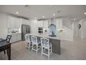 Spacious kitchen featuring a large center island, stainless steel appliances, and stylish white cabinets at 17966 Grand Prosperity Dr, Venice, FL 34293