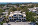 Aerial view of condo complex showcasing ocean views and proximity to a golf course and waterways at 1912 Harbourside Dr # 602, Longboat Key, FL 34228
