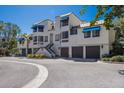 Charming condo building with well-maintained landscaping, private garages, and a coastal aesthetic at 1912 Harbourside Dr # 602, Longboat Key, FL 34228