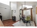 Bright dining area with unique light fixture, large window and sliding door to balcony at 2224 Bahia Vista St # E6, Sarasota, FL 34239