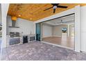 Cozy outdoor kitchen featuring a grill, mini-fridge, and sink, perfect for outdoor entertaining at 2523 Dixon Ter, Port Charlotte, FL 33981
