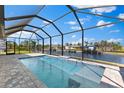 Inviting screened-in pool with serene views of the canal and the surrounding neighborhood at 2523 Dixon Ter, Port Charlotte, FL 33981