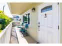Charming balcony with seating area, a glimpse of tropical foliage, and a well-lit entryway at 3000 Gulf Dr # 3, Holmes Beach, FL 34217
