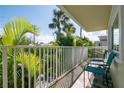 Relaxing balcony with comfortable seating and lush tropical foliage, perfect for unwinding at 3000 Gulf Dr # 3, Holmes Beach, FL 34217