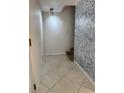 Inviting hallway features neutral walls, tiled flooring, and bright lighting, creating a welcoming entrance at 306 Barlow Ave # 77, Sarasota, FL 34232