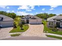 Beautiful one-story home with a three-car garage, paver driveway, and well-maintained landscaping at 3617 Wild Blossom Pl, Parrish, FL 34219