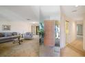 Spacious living room with large mirror, providing an open feel and view of the front door and entryway at 3640 Aster Dr, Sarasota, FL 34233