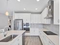 Bright kitchen features stainless steel appliances, white cabinetry, and quartz countertops at 3663 Quiet Dr, Sarasota, FL 34240