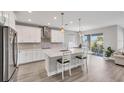 Modern kitchen with stainless steel appliances, a quartz countertop island and an open floor plan at 3663 Quiet Dr, Sarasota, FL 34240
