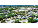An aerial view of a neighborhood featuring well-maintained homes, mature trees, swimming pools, and convenient street access at 4008 Cape Vista Dr, Bradenton, FL 34209