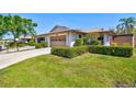 Quaint villa featuring a lush lawn, manicured shrubbery, attached garage, and a cozy neighborhood at 4451 Atwood Cay Cir # 7, Sarasota, FL 34233