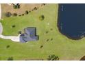 Aerial view of a lovely home with a large yard and a beautiful lake at 4606 Lake Fox Pl, Parrish, FL 34219