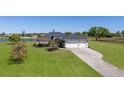 Beautiful home with a sprawling lawn, three car garage, and a serene lake view at 4606 Lake Fox Pl, Parrish, FL 34219