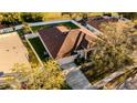 Ariel view of charming home with mature landscaping, manicured yard, and a large driveway and two car garage at 4706 Cayo Costa Pl, Bradenton, FL 34203
