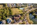 Aerial view of the property and surrounding neighborhood, featuring a community pool, playground and lake at 4706 Cayo Costa Pl, Bradenton, FL 34203