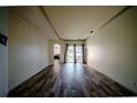 Spacious living room featuring wood floors, neutral paint, and access to the backyard patio at 4706 Cayo Costa Pl, Bradenton, FL 34203
