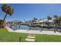 Dock with boat lift and views of waterfront homes and canals in a coastal neighborhood at 500 Halyard Ln, Longboat Key, FL 34228