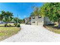 Charming two-story home with a front yard featuring white gravel and a convenient attached garage at 5311 San Jose Dr, Sarasota, FL 34235