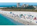 A scenic view of a vibrant beach with people enjoying the sun and surf on a clear day at 6263 Midnight Pass Rd # 301, Sarasota, FL 34242