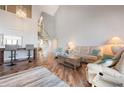 Bright living room featuring wood floors, comfortable seating, and a distinctive spiral staircase to the upper level at 6263 Midnight Pass Rd # 301, Sarasota, FL 34242