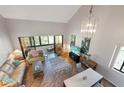 Overhead view of the living room showcases the open layout, high ceilings, wood flooring, and natural light at 6263 Midnight Pass Rd # 301, Sarasota, FL 34242